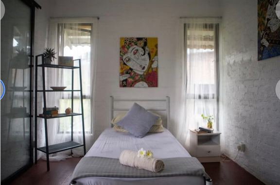 Beautiful bed, two windows and picture above head board